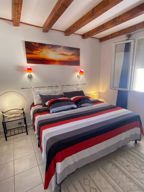 Chambre double avec poutres apparentes et lit 160×200 – Gîte Villa Jeff