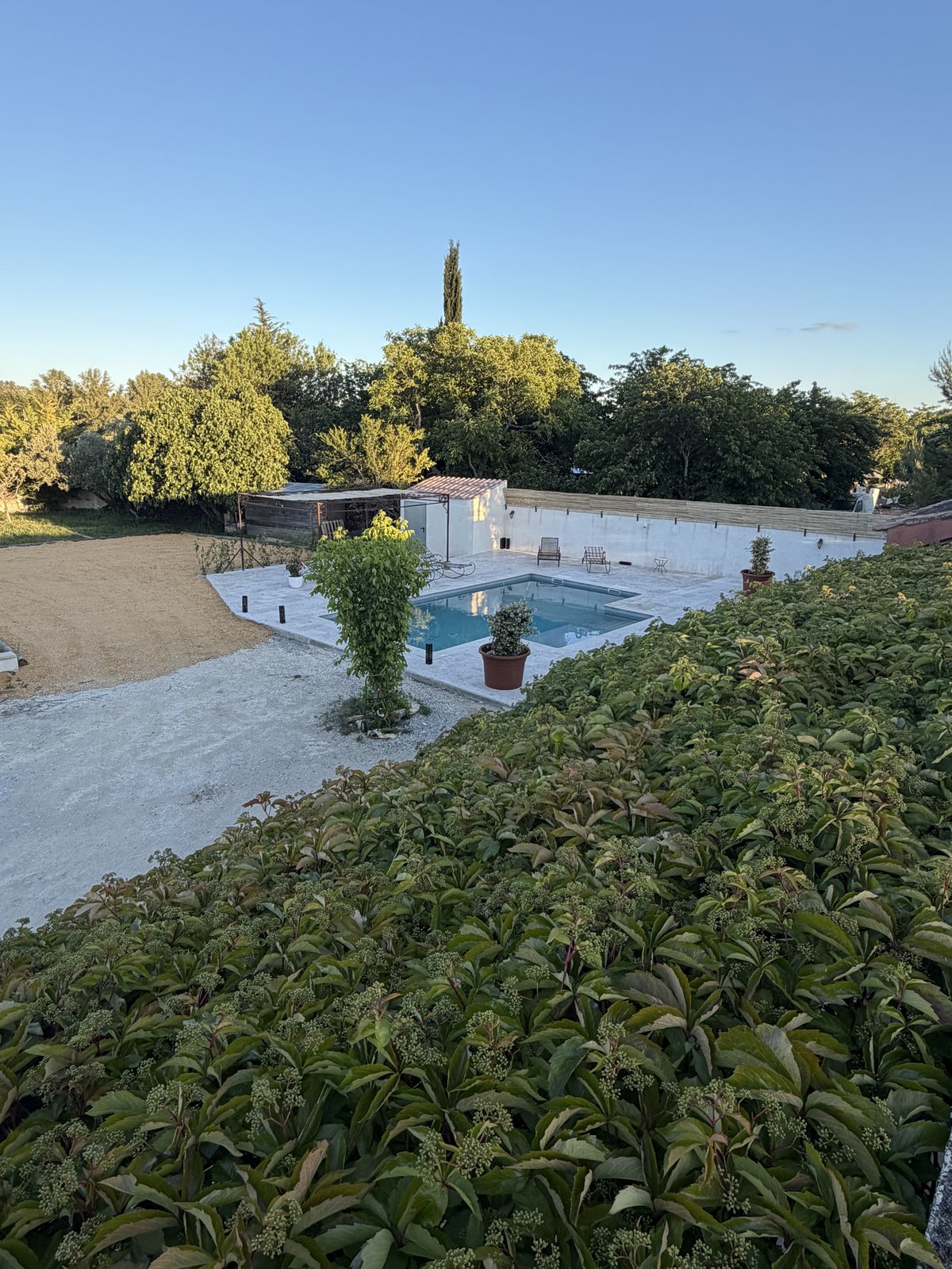 Vue plongeante sur la piscine et le jardin depuis la terrasse haute – Villa Jeff